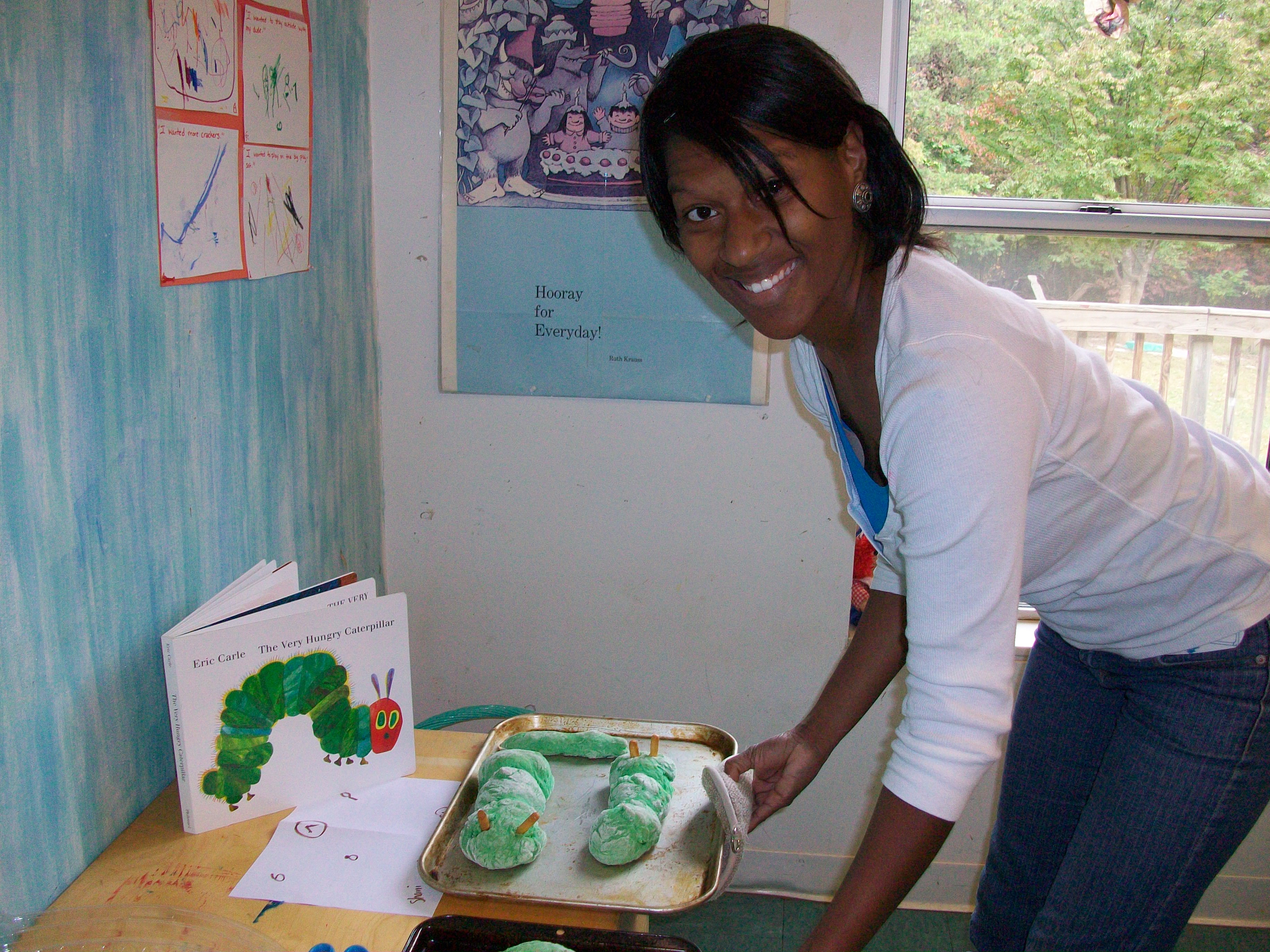 Nursery teacher shows off the caterpillar-green bread made by the preschool students.